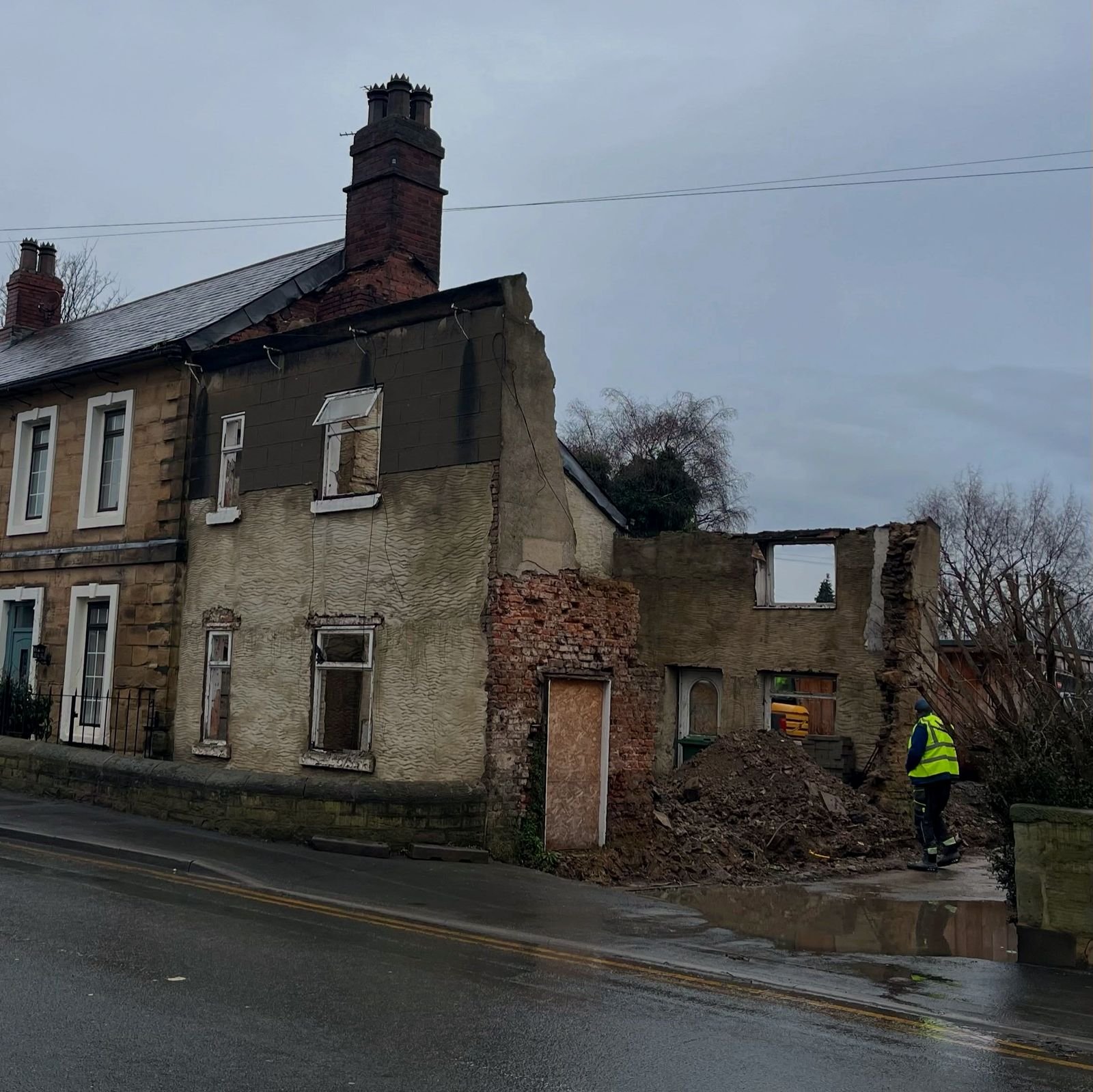 The same property before rebuild — derelict, with roof and rear wall partially collapsed